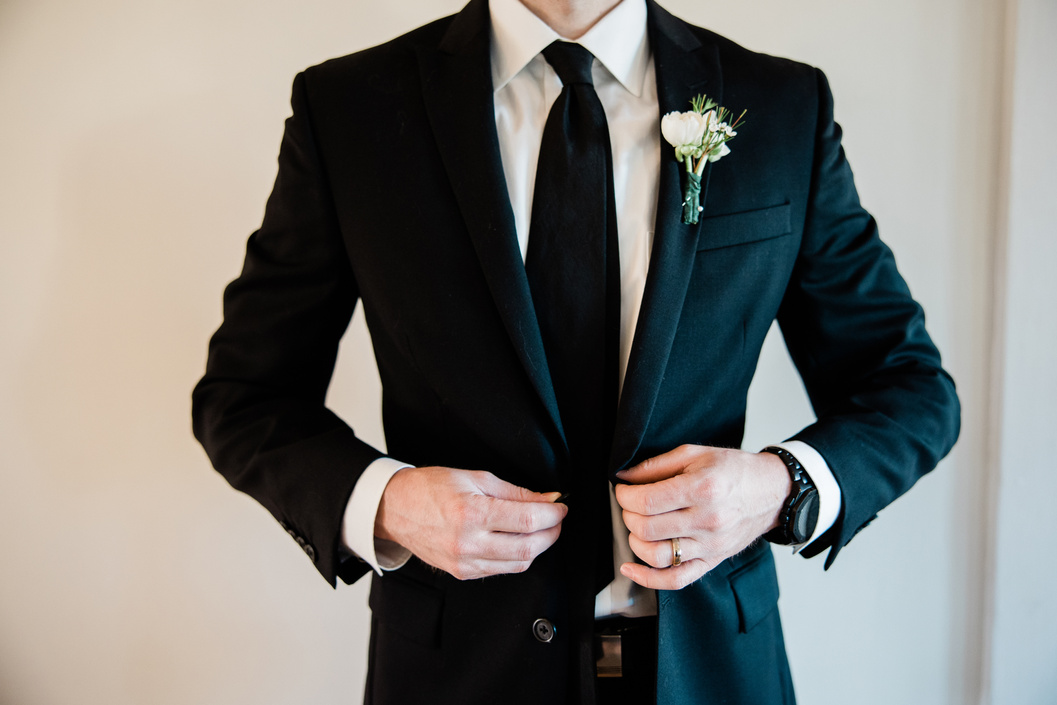 Groom Buttoning His Wedding Suit